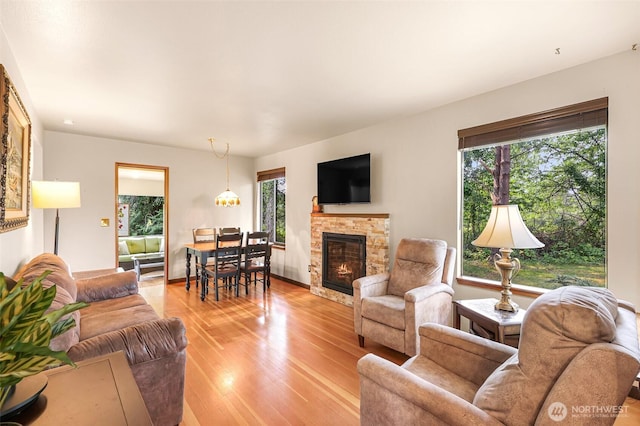 832 Elm Ave, Blaine, WA 98230 - living room featuring plenty of natural light, light wood finished floors, and a stone fireplace