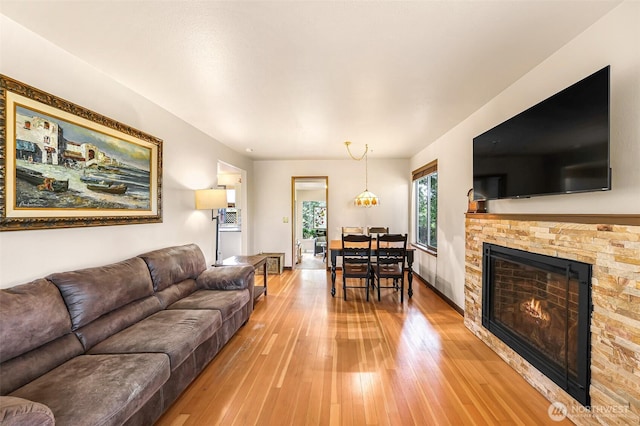 832 Elm Ave, Blaine, WA 98230 - living area with light wood-style flooring and a warm lit fireplace