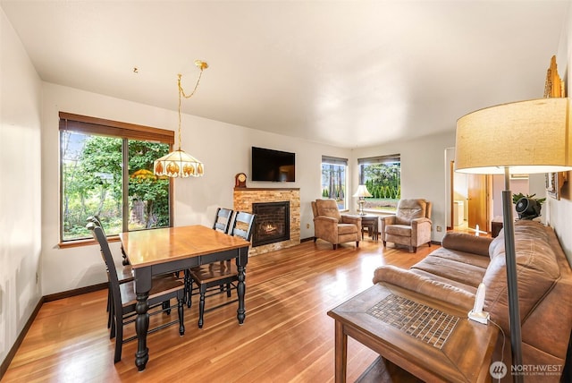 832 Elm Ave, Blaine, WA 98230 - dining space with healthy amount of natural light, light wood-style floors, and a fireplace
