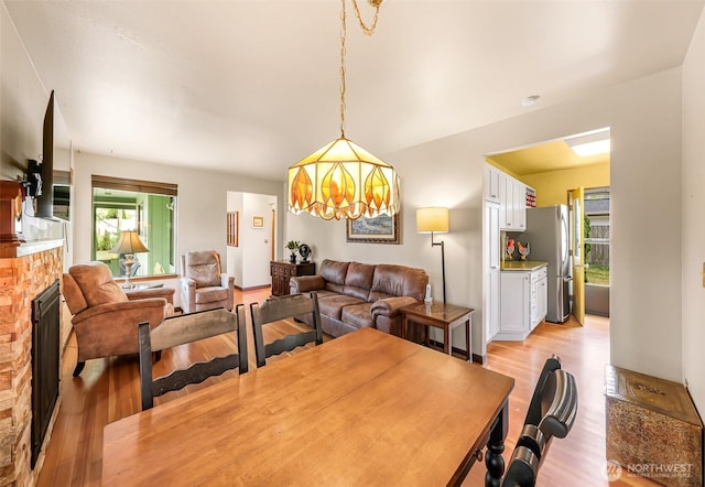832 Elm Ave, Blaine, WA 98230 - dining space featuring light wood-style floors and a brick fireplace
