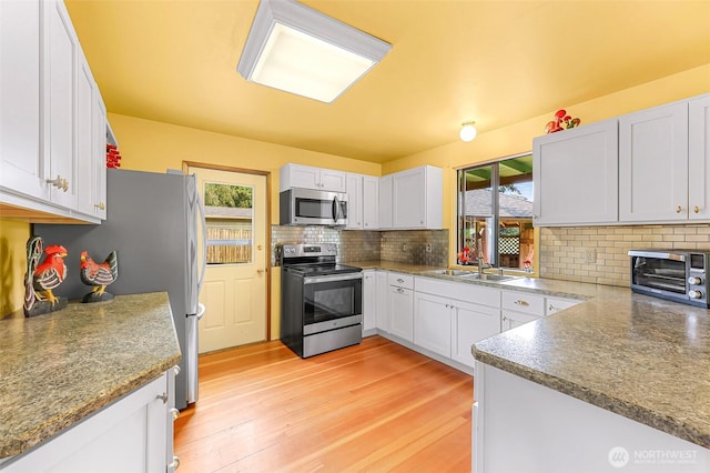 832 Elm Ave, Blaine, WA 98230 - kitchen with appliances with stainless steel finishes, backsplash, white cabinets, and a sink