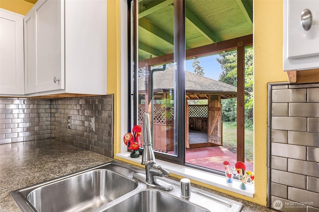 832 Elm Ave, Blaine, WA 98230 - kitchen view of tasteful backsplash, white cabinetry, and a sink