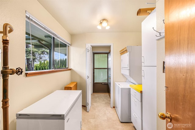 832 Elm Ave, Blaine, WA 98230 - washroom featuring stacked washer / drying machine, cabinet space, and light tile patterned floors