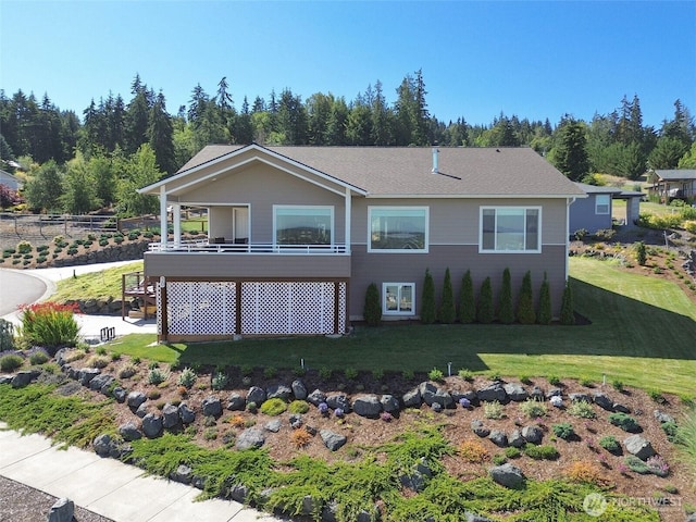 rear view of house with a yard