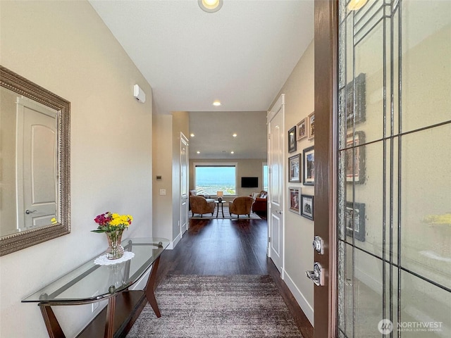 corridor featuring recessed lighting, baseboards, and wood finished floors