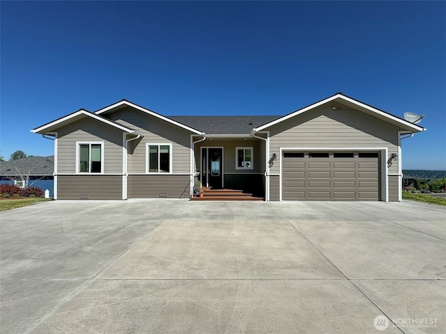 ranch-style home with concrete driveway and an attached garage