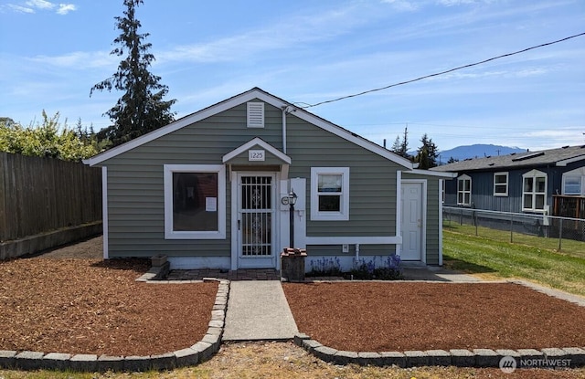 1225 W 5th St, Port Angeles, WA 98363 - bungalow-style house with fence and a mountain view