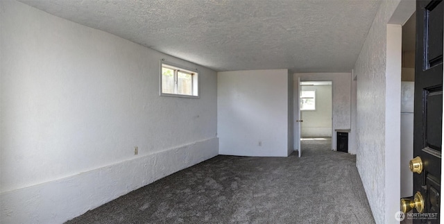 1225 W 5th St, Port Angeles, WA 98363 - spare room featuring a wealth of natural light, a textured ceiling, and a textured wall
