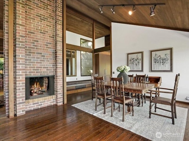 4400 E Mercer Way, Mercer Island, WA 98040 - dining room with lofted ceiling, track lighting, hardwood / wood-style flooring, wooden ceiling, and a brick fireplace
