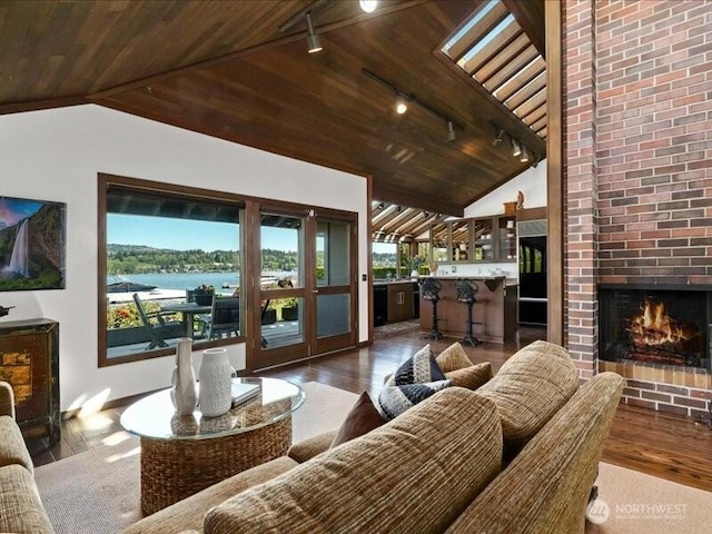4400 E Mercer Way, Mercer Island, WA 98040 - living room featuring track lighting, vaulted ceiling, wooden ceiling, wood finished floors, and a brick fireplace