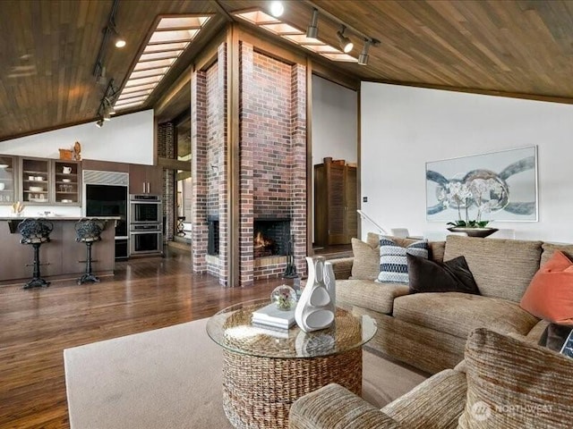 4400 E Mercer Way, Mercer Island, WA 98040 - living room featuring wooden ceiling, rail lighting, wood finished floors, high vaulted ceiling, and a fireplace