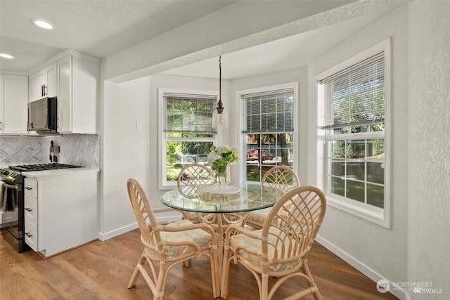 7236 Twin Cedar Ln SE, Tumwater, WA 98501 - dining room featuring baseboards, wood finished floors, and recessed lighting