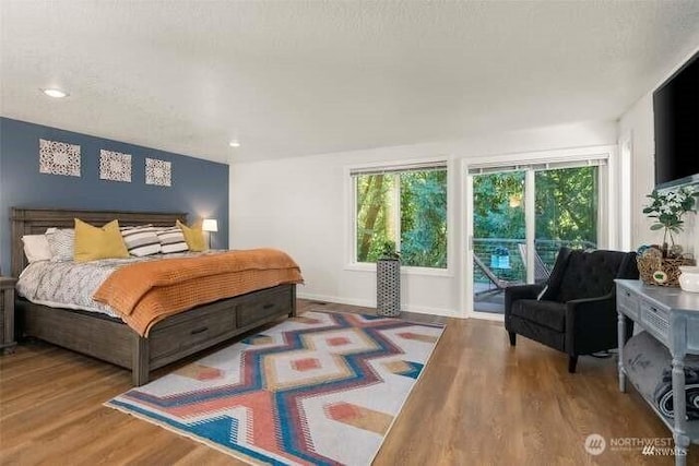 7236 Twin Cedar Ln SE, Tumwater, WA 98501 - bedroom featuring access to outside, wood finished floors, recessed lighting, and baseboards