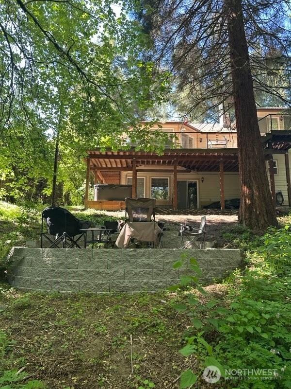 7236 Twin Cedar Ln SE, Tumwater, WA 98501 - rear view of property featuring a pergola and a wooden deck