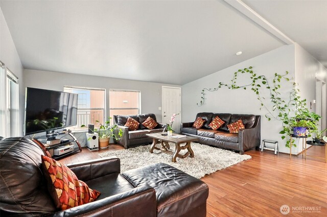 living area with lofted ceiling and wood finished floors