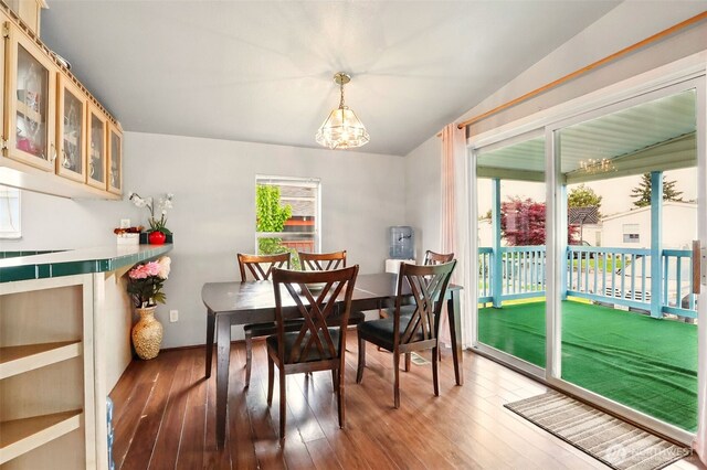 dining area featuring hardwood / wood-style flooring and a chandelier