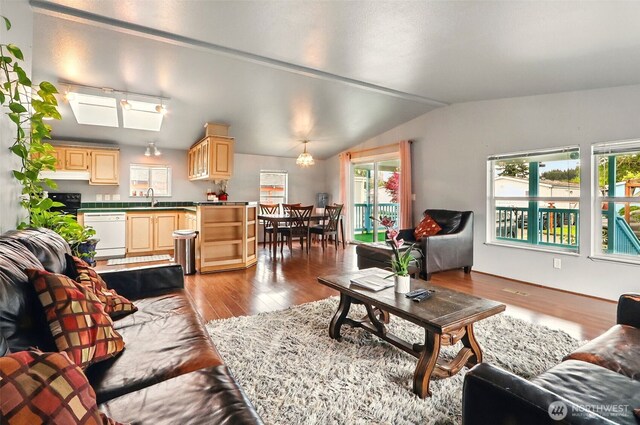 living room with lofted ceiling and wood finished floors