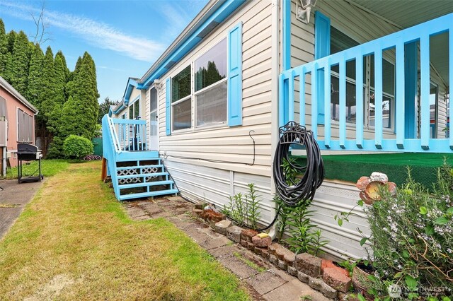 view of side of property with a yard
