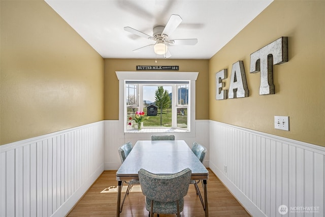 28009 SE 456th St, Enumclaw, WA 98022 - dining room with a ceiling fan, a wainscoted wall, and wood finished floors