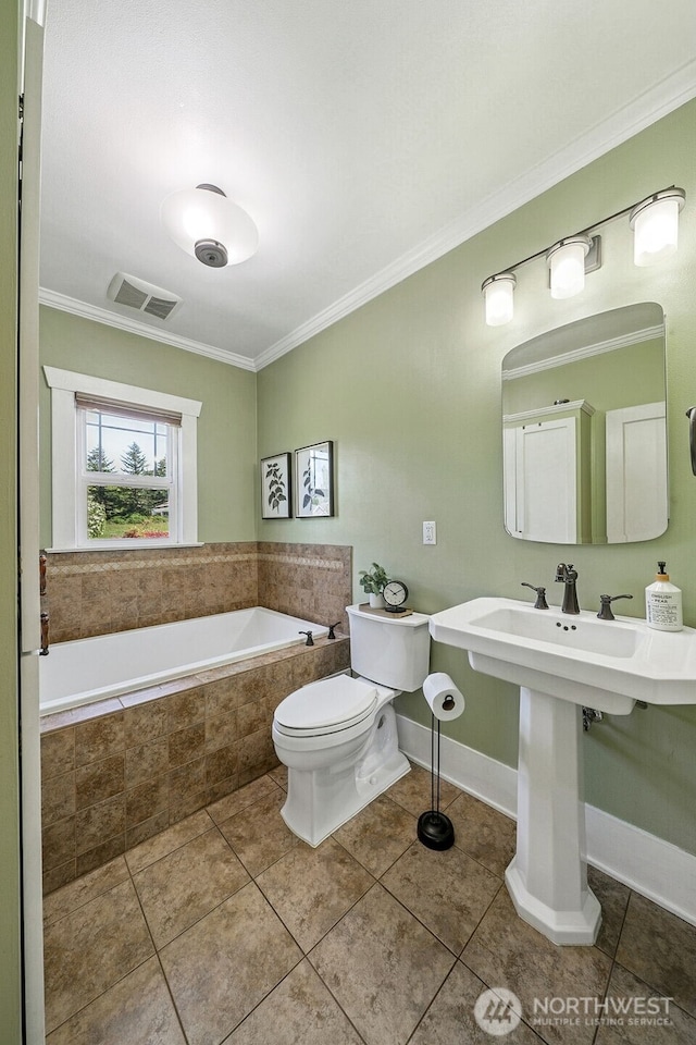 28009 SE 456th St, Enumclaw, WA 98022 - bathroom featuring ornamental molding, tile patterned floors, a relaxing tiled tub, toilet, and baseboards