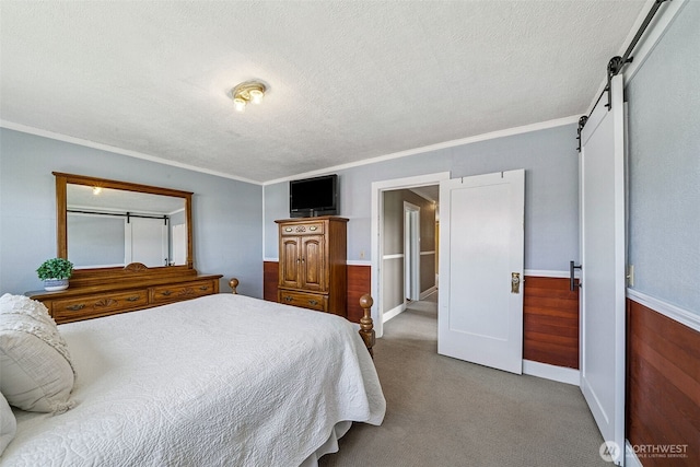 28009 SE 456th St, Enumclaw, WA 98022 - bedroom featuring a textured ceiling, carpet, a barn door, crown molding, and baseboards