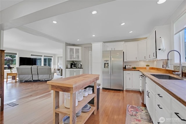 47 W Sunny Sands Rd, Cathlamet, WA 98612 - kitchen featuring light wood-style flooring, appliances with stainless steel finishes, a sink, and white cabinets