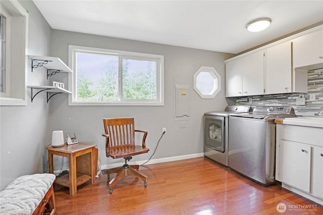 47 W Sunny Sands Rd, Cathlamet, WA 98612 - washroom featuring a wealth of natural light, light wood-style floors, washer and dryer, and cabinet space