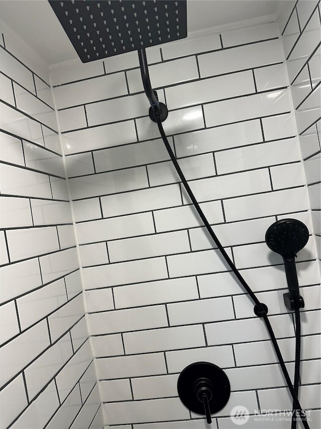 full bath with a tile shower