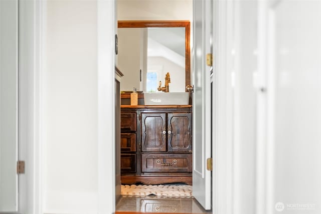 interior space with vanity and wood finished floors