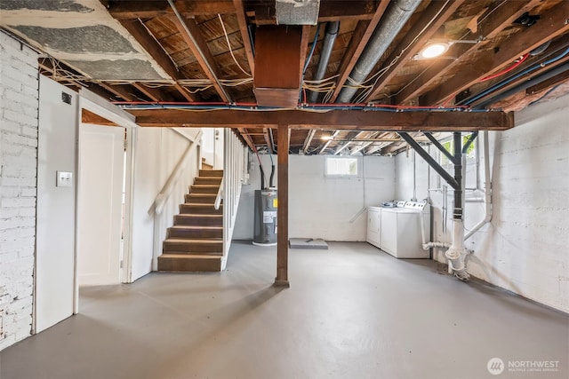 basement with electric water heater, stairs, and separate washer and dryer
