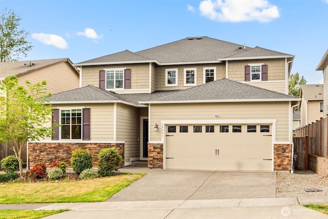 10421 12th St E, Edgewood, WA 98372 - view of front of house with stone siding, driveway, an attached garage, and roof with shingles