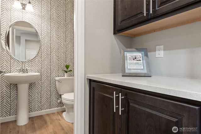 10421 12th St E, Edgewood, WA 98372 - bathroom with wallpapered walls and wood finished floors