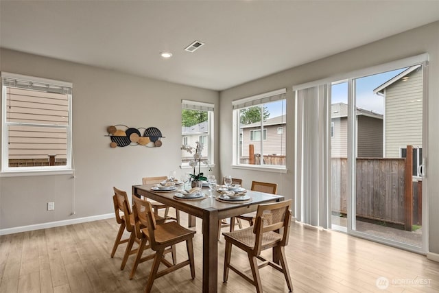 dining room with wood-type flooring, baseboards, and recessed lighting