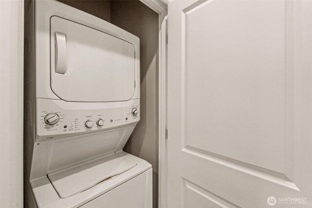 laundry room featuring stacked washing machine and dryer
