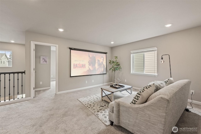 carpeted living area with recessed lighting and baseboards