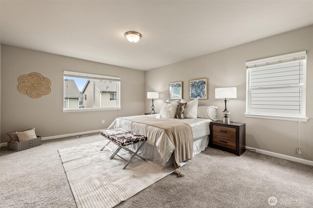 bedroom with carpet floors and baseboards