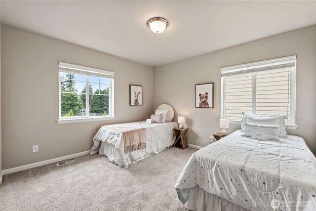 bedroom with carpet floors and baseboards