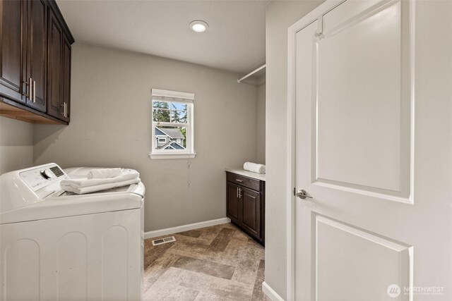 clothes washing area with cabinet space, separate washer and dryer, baseboards, and recessed lighting