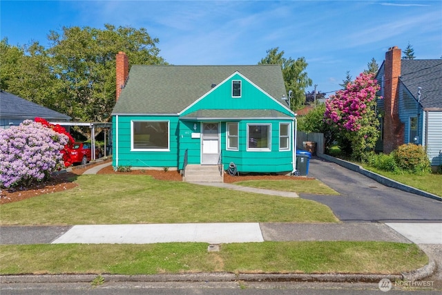 6027 S Bell St, Tacoma, WA 98408 - bungalow-style house with entry steps, roof with shingles, a front yard, and a chimney