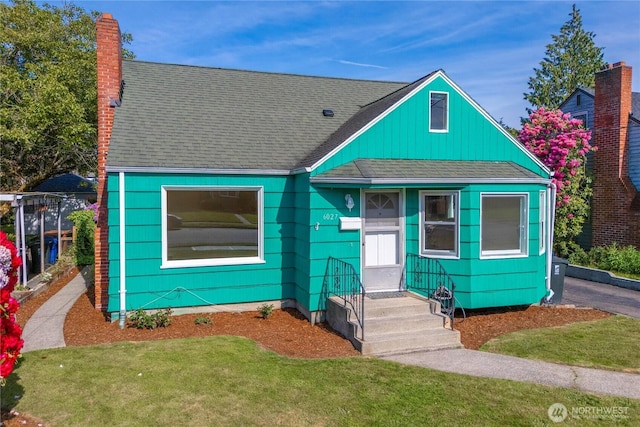 6027 S Bell St, Tacoma, WA 98408 - bungalow-style house with a chimney, a front yard, and a shingled roof