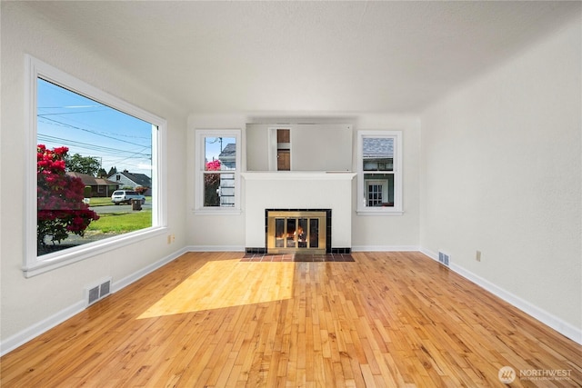 6027 S Bell St, Tacoma, WA 98408 - unfurnished living room featuring hardwood / wood-style floors, a fireplace with flush hearth, and baseboards
