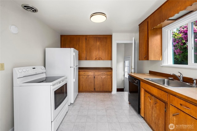 6027 S Bell St, Tacoma, WA 98408 - kitchen with white appliances, a sink, and brown cabinetry