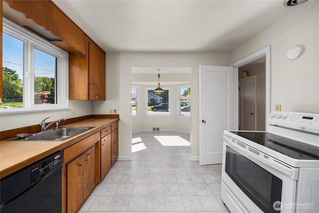 6027 S Bell St, Tacoma, WA 98408 - kitchen featuring white electric stove, dishwasher, a sink, and brown cabinetry