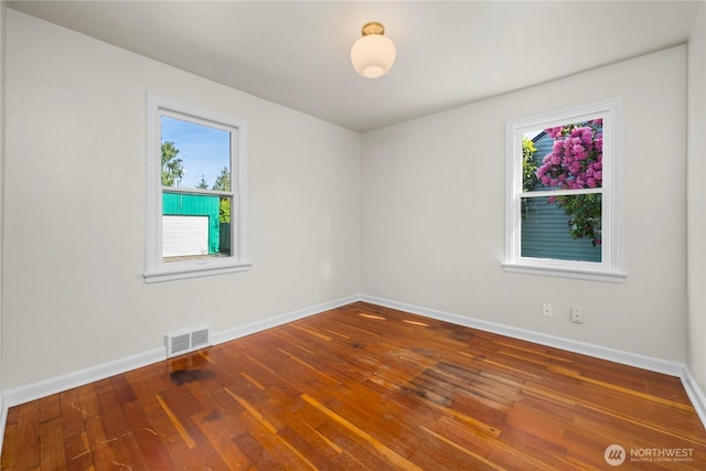 6027 S Bell St, Tacoma, WA 98408 - spare room with wood-type flooring and baseboards
