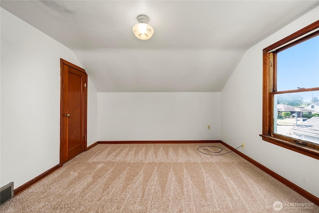 6027 S Bell St, Tacoma, WA 98408 - additional living space featuring vaulted ceiling, light carpet, baseboards, and plenty of natural light