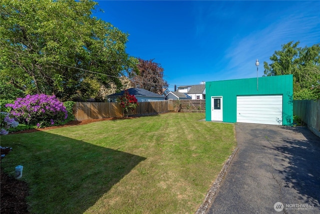 6027 S Bell St, Tacoma, WA 98408 - view of yard featuring driveway, a garage, and an outbuilding