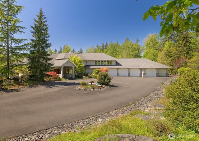 view of front of property featuring a garage and aphalt driveway