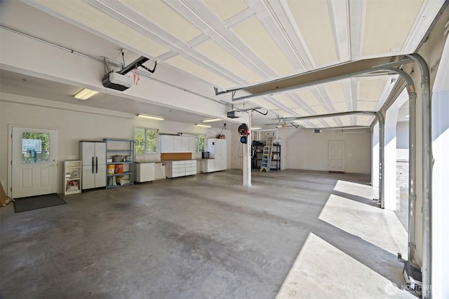 garage with white fridge, a garage door opener, and refrigerator