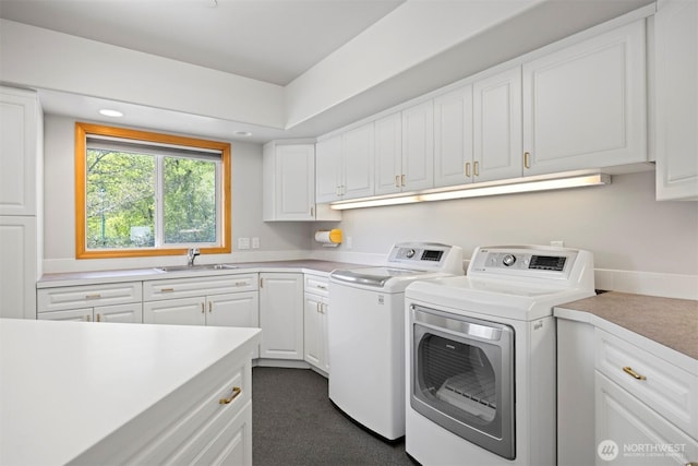laundry area featuring washer and clothes dryer, cabinet space, a sink, and recessed lighting