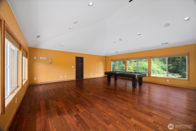 empty room featuring billiards, wood finished floors, visible vents, and high vaulted ceiling